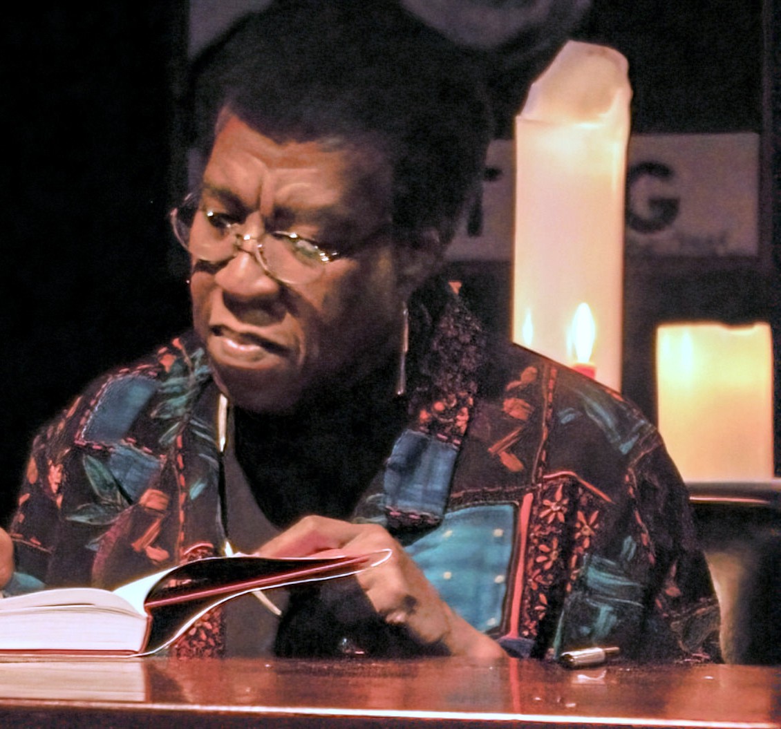 Octavia Butler signing a book by candlelight